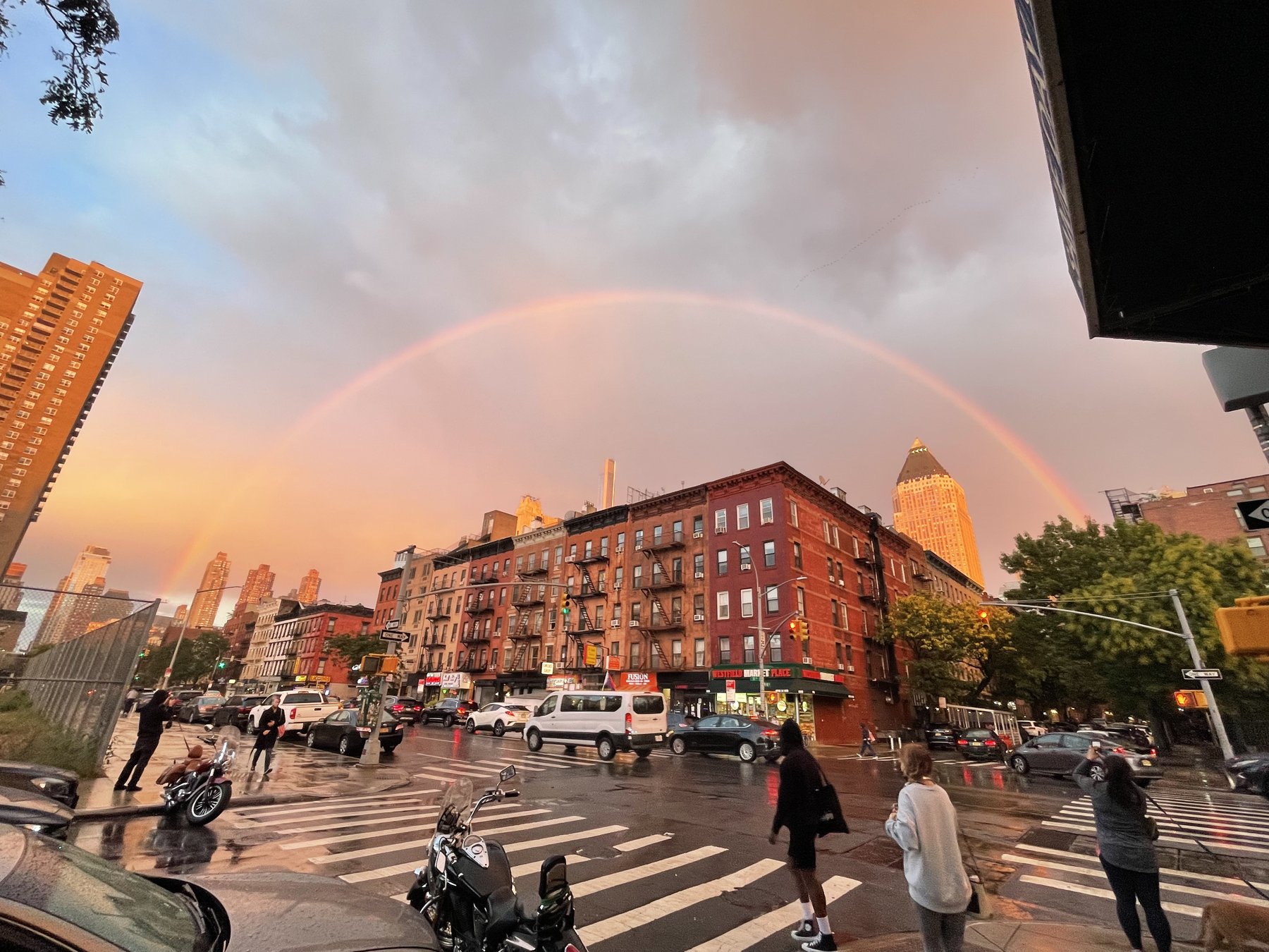 Rainbow over a city street after rain