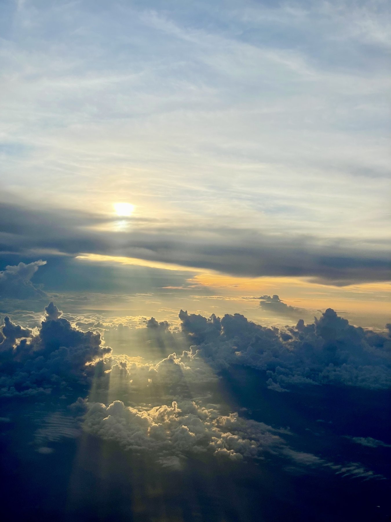 Sunbeams through clouds from above
